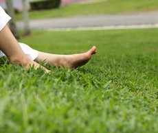 Feet of a woman in a yard lawn